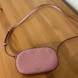 Kate Spade Glimmer Glitter Oval Camera Crossbody Bag in Mitten Pink.